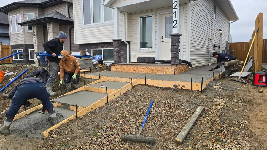 Crew preparing formwork and base for a residential concrete pad