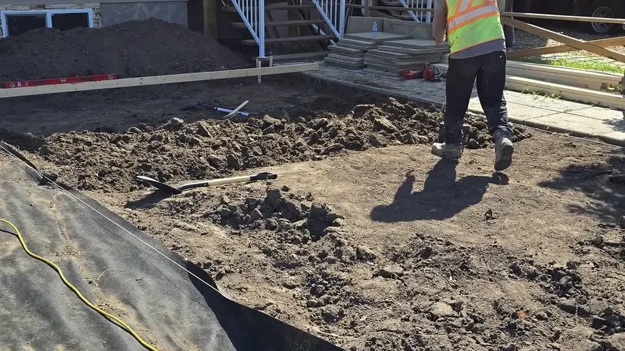 Excavation and preparation after concrete removal beside a Saskatoon home