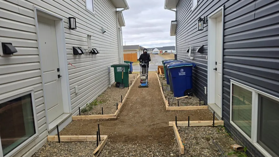 Compacted base preparation for a walkway project in Saskatoon