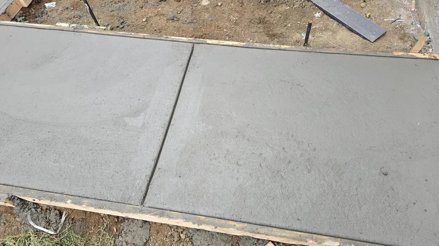 Fresh concrete walkway surface and control-joint detail in Saskatoon