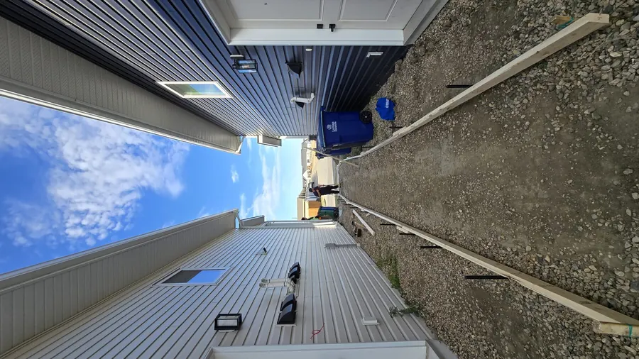 Concrete walkway forms prepared between Saskatoon homes