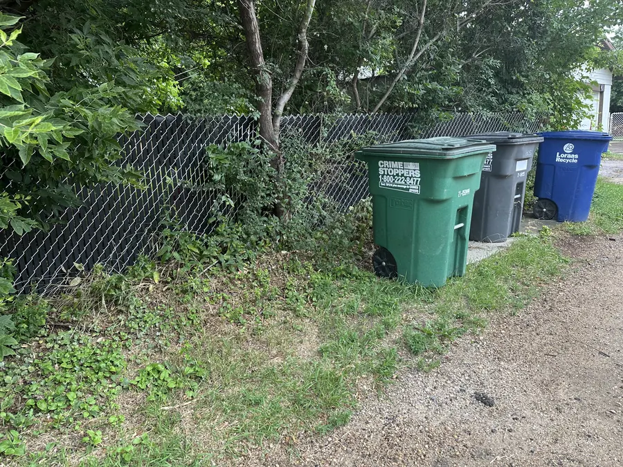 Existing chain-link fence and site conditions in Saskatoon