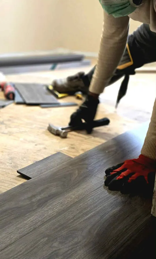 Vinyl plank flooring being installed in a Saskatoon room