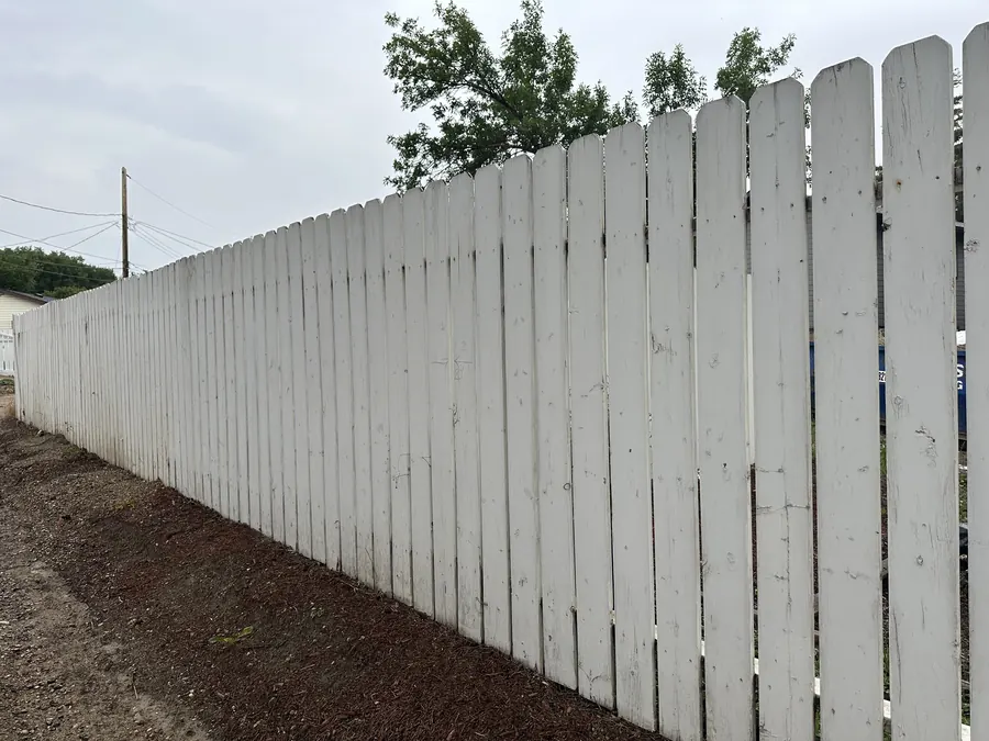 Painted wood privacy fence along a Saskatoon property