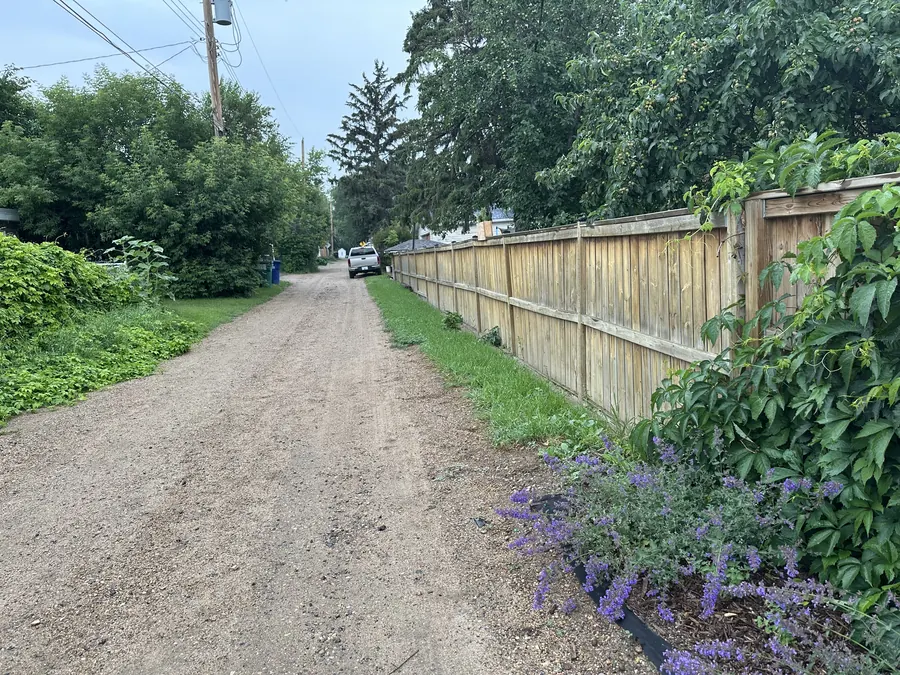 Long existing wood fence along a Saskatoon alley